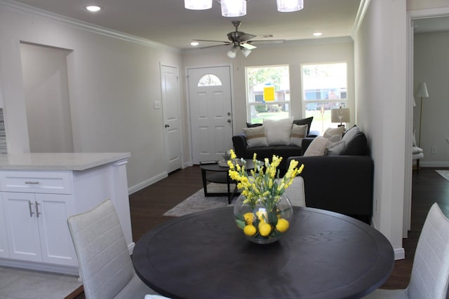 dining room with dark wood-style floors, baseboards, crown molding, and recessed lighting