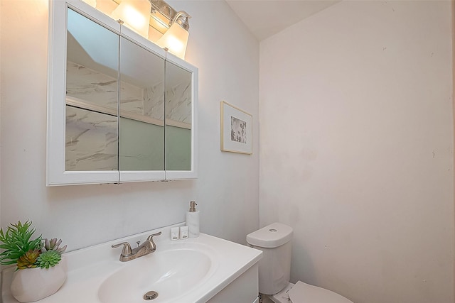 bathroom featuring toilet and vanity