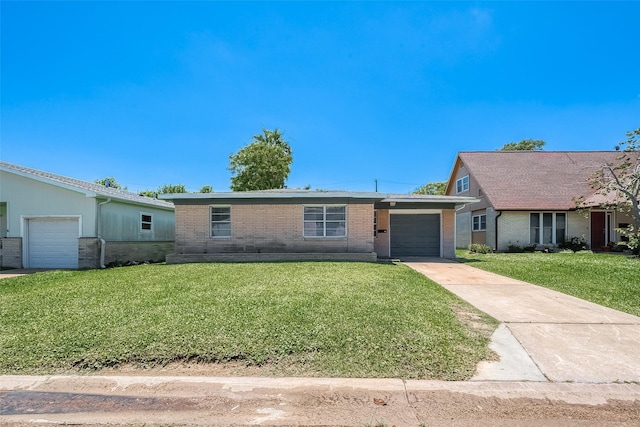 ranch-style house featuring concrete driveway, a front lawn, an attached garage, and brick siding