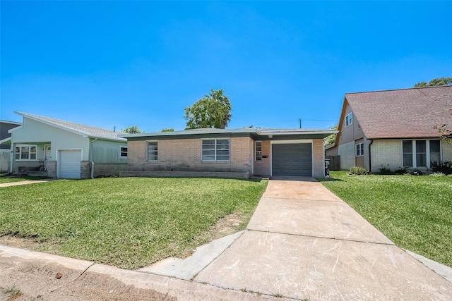 single story home with a garage, brick siding, driveway, and a front lawn