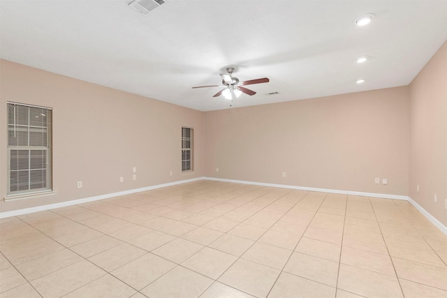 empty room featuring ceiling fan, visible vents, baseboards, and recessed lighting