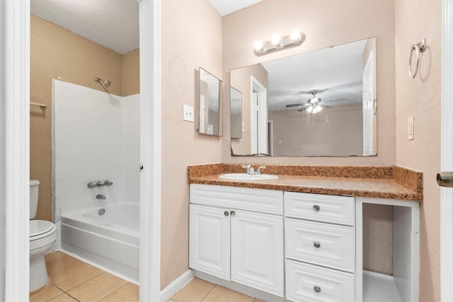 bathroom with toilet, ceiling fan, tile patterned floors, vanity, and shower / bathing tub combination