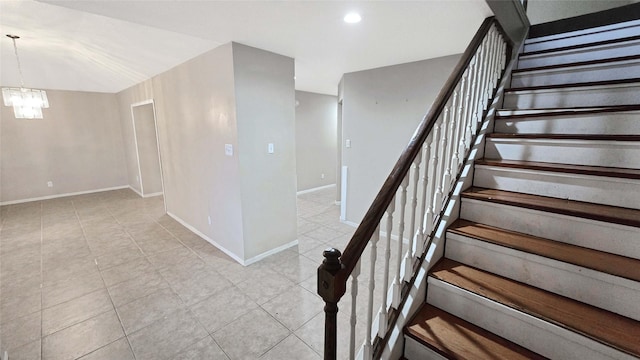 staircase with tile patterned flooring, a chandelier, baseboards, and recessed lighting