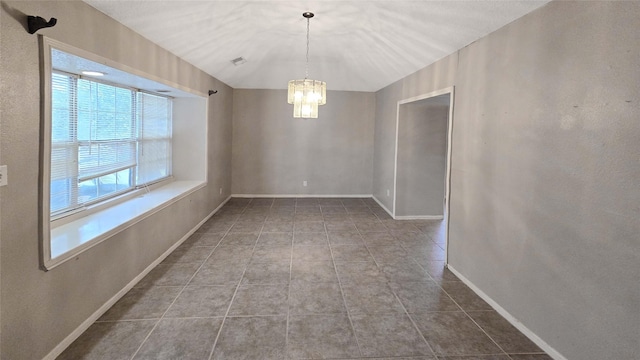 tiled spare room featuring a notable chandelier, visible vents, and baseboards