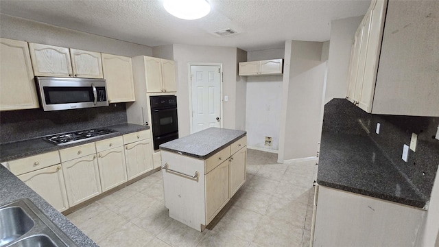 kitchen featuring dark countertops, a kitchen island, appliances with stainless steel finishes, and decorative backsplash