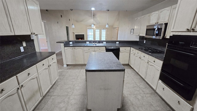 kitchen featuring a warm lit fireplace, stainless steel appliances, a peninsula, a center island, and dark countertops