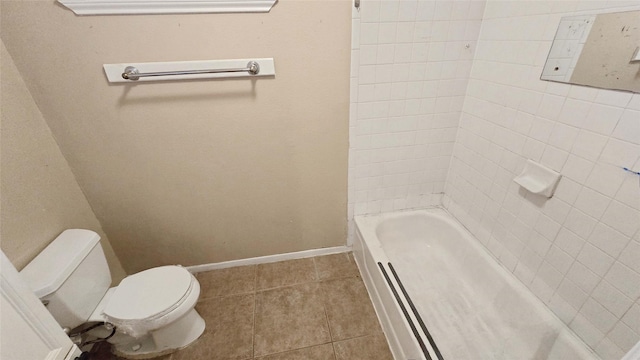 bathroom featuring a bathtub, baseboards, toilet, and tile patterned floors