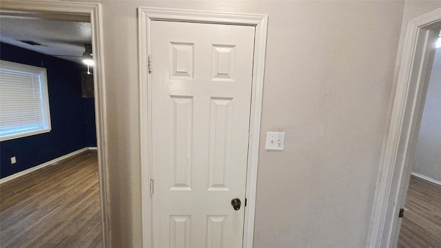 room details featuring wood finished floors, visible vents, and baseboards