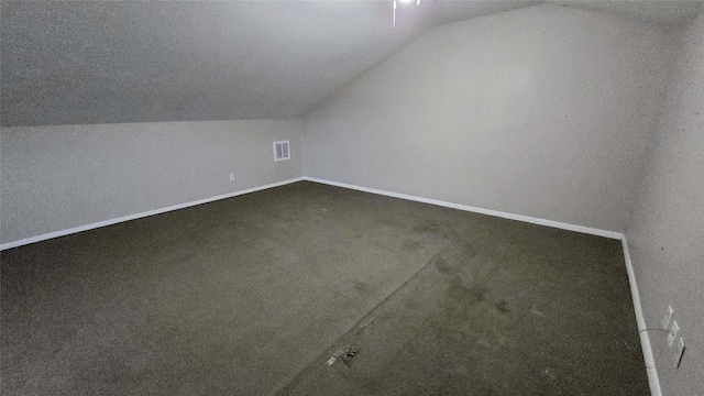 bonus room with lofted ceiling, carpet flooring, visible vents, and baseboards