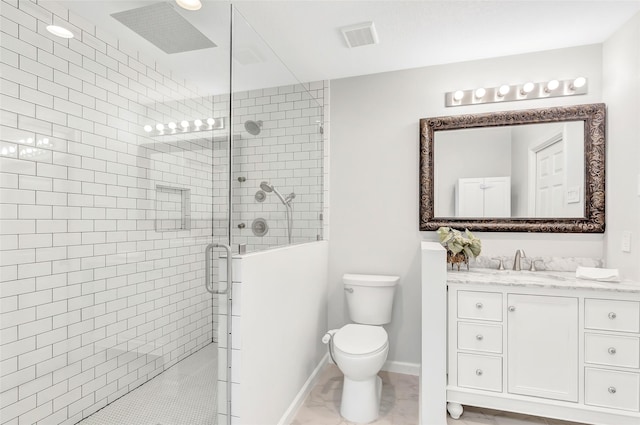 full bath with visible vents, baseboards, toilet, vanity, and a shower stall