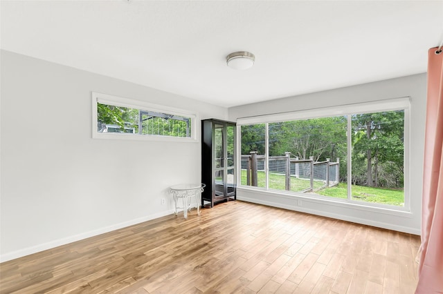 spare room featuring light wood-style flooring and baseboards