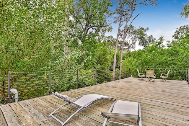 wooden terrace with outdoor dining area