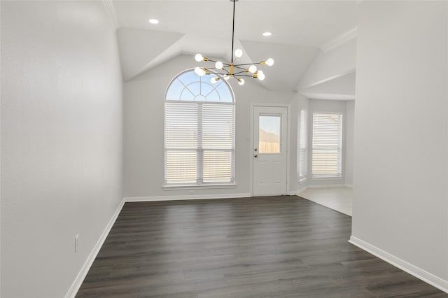 unfurnished dining area featuring lofted ceiling, recessed lighting, baseboards, dark wood finished floors, and an inviting chandelier