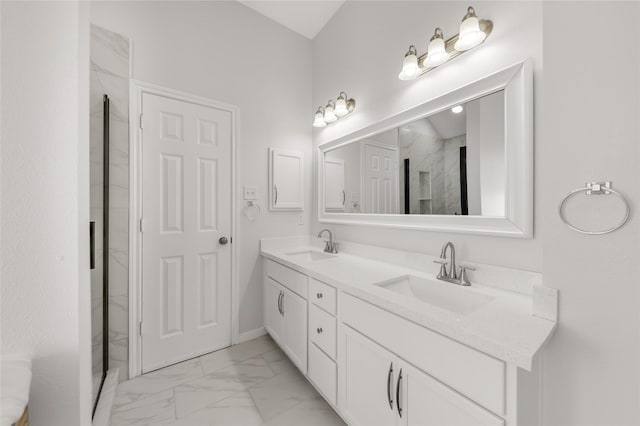 bathroom with marble finish floor, a sink, a shower stall, and double vanity