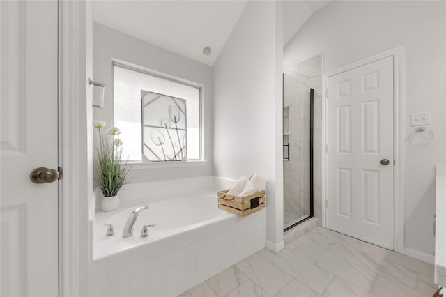 full bath with lofted ceiling, marble finish floor, a stall shower, and a garden tub