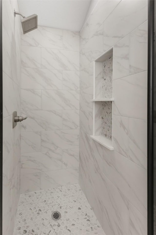 full bath with a tile shower