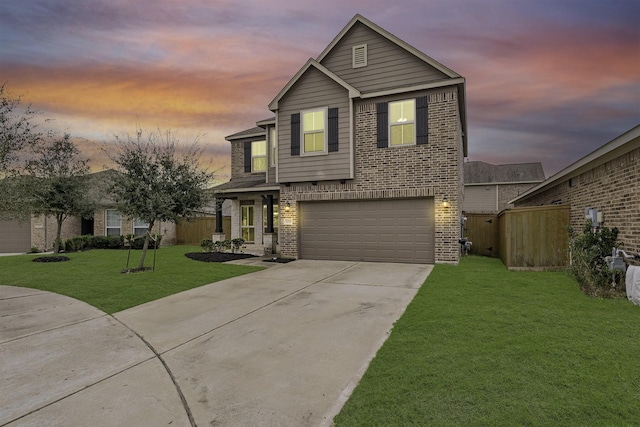 traditional home featuring driveway, a garage, fence, a yard, and brick siding