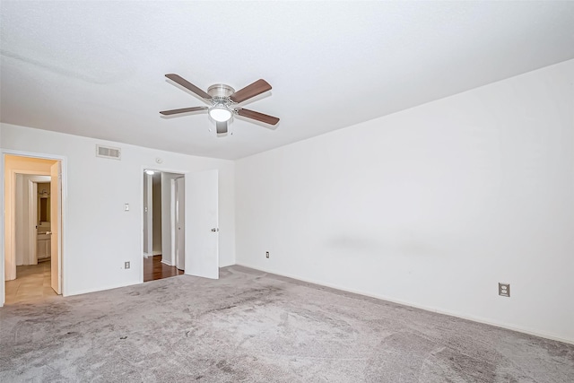 unfurnished bedroom with a ceiling fan, light carpet, and visible vents