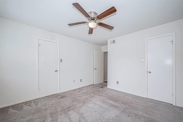 unfurnished bedroom with light colored carpet, ceiling fan, and visible vents