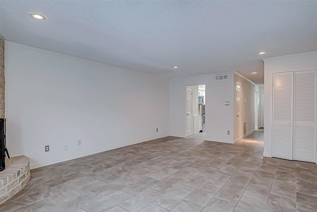 unfurnished living room featuring a textured ceiling, visible vents, and recessed lighting