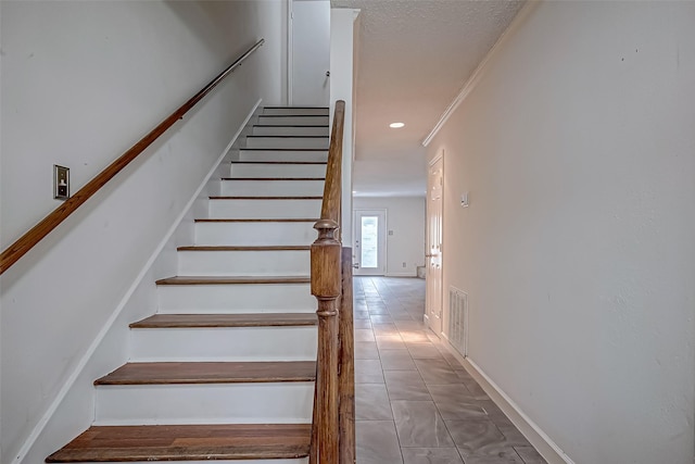 staircase with recessed lighting, visible vents, crown molding, and tile patterned floors