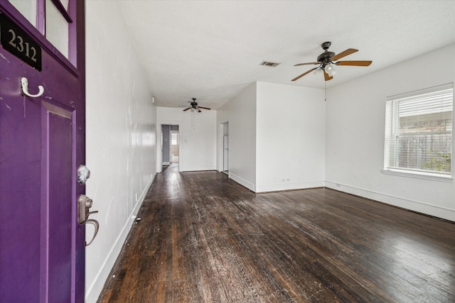 entrance foyer featuring ceiling fan, dark wood finished floors, visible vents, and baseboards