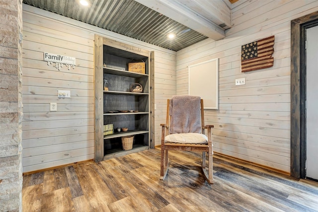 sitting room featuring recessed lighting, beamed ceiling, wooden walls, and wood finished floors