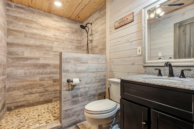 bathroom with toilet, wood ceiling, wooden walls, vanity, and a walk in shower