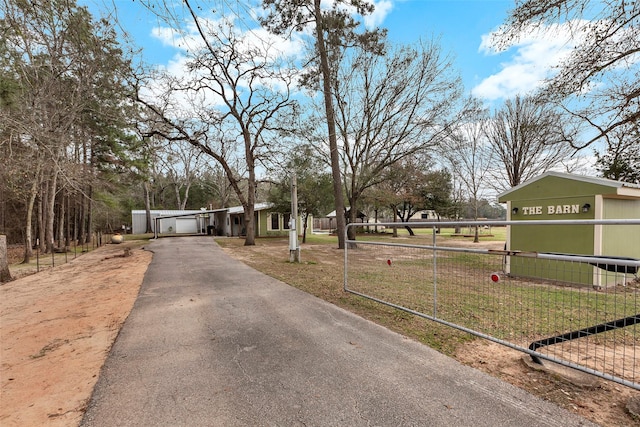 view of street with driveway and a gated entry