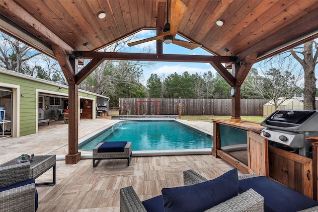 view of pool with a fenced backyard, grilling area, a fenced in pool, and a patio