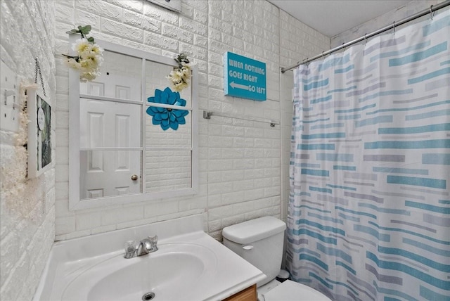 bathroom featuring toilet, curtained shower, tile walls, and vanity