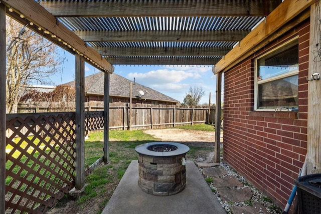 view of patio with a fire pit, a fenced backyard, and a pergola