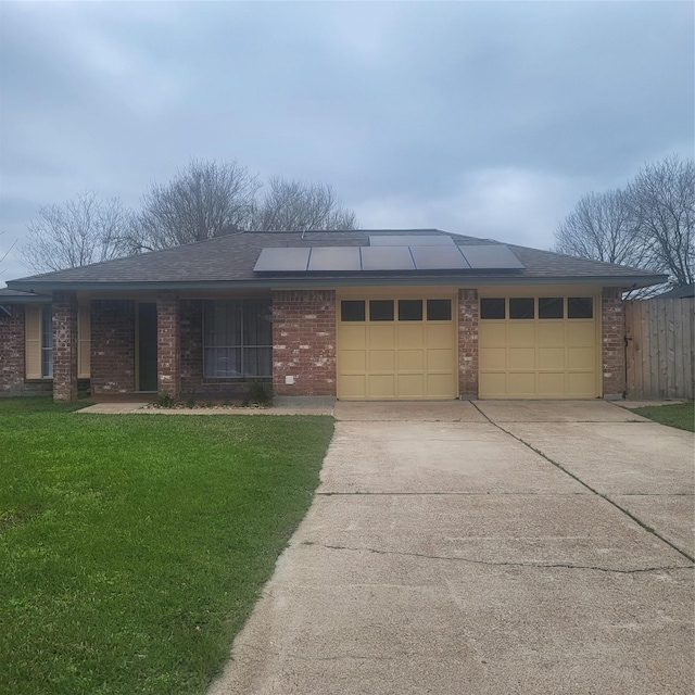 ranch-style house with a garage, concrete driveway, brick siding, and a front lawn