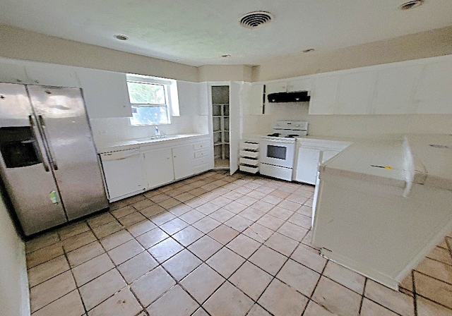 kitchen featuring light countertops, visible vents, white cabinets, ventilation hood, and white appliances