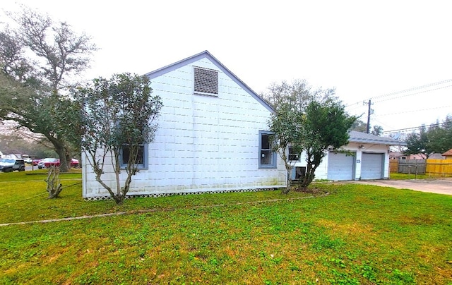 view of home's exterior with driveway, an attached garage, and a lawn