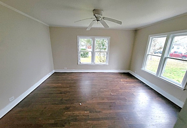 unfurnished room featuring dark wood-style floors, ornamental molding, a ceiling fan, and baseboards