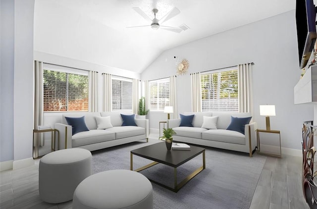 living area with vaulted ceiling, wood finished floors, a ceiling fan, and baseboards