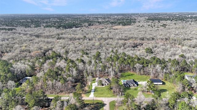 birds eye view of property featuring a forest view