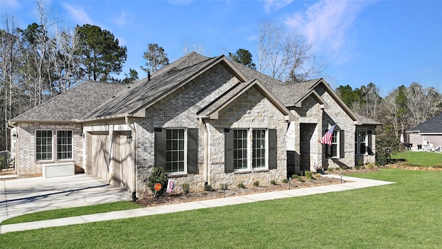 french country home with brick siding, concrete driveway, an attached garage, stone siding, and a front lawn