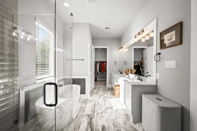 full bathroom featuring vanity, visible vents, marble finish floor, a spacious closet, and a shower stall