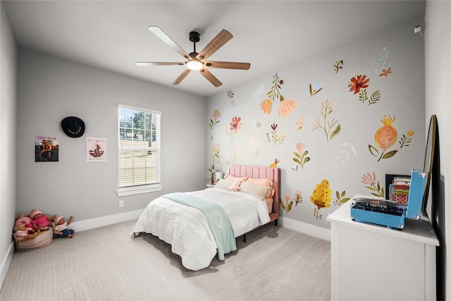 bedroom with light colored carpet, ceiling fan, and baseboards