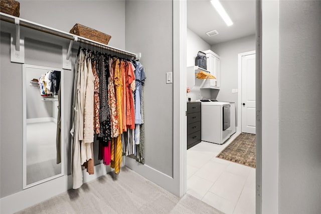 spacious closet with washing machine and dryer and visible vents