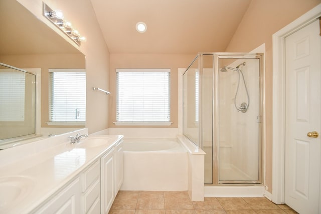 full bath with a garden tub, a stall shower, a sink, and tile patterned floors