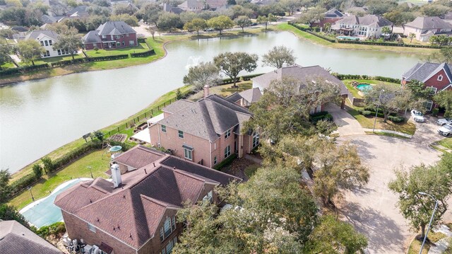 drone / aerial view with a residential view and a water view