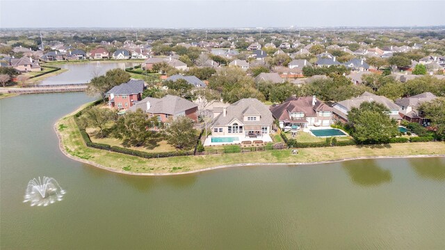 drone / aerial view with a residential view and a water view