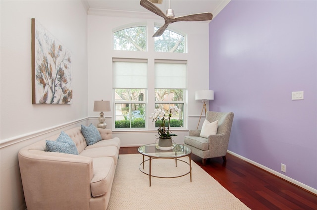 sitting room with baseboards, a ceiling fan, dark wood-style floors, and crown molding