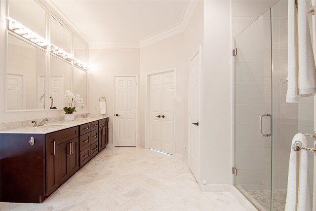 bathroom with a sink, double vanity, ornamental molding, and a shower stall