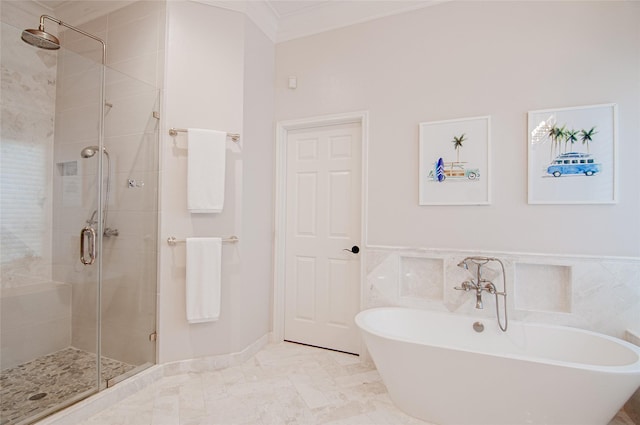 bathroom featuring a soaking tub, wainscoting, a shower stall, and crown molding