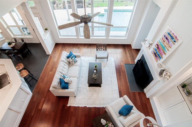 living room with wood finished floors and a ceiling fan