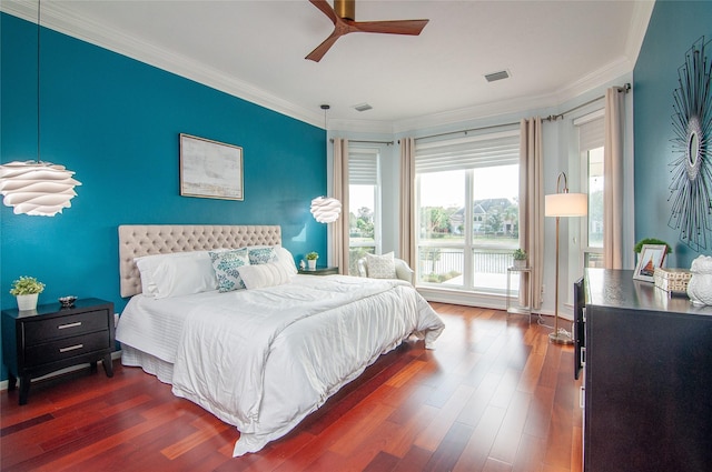 bedroom with visible vents, dark wood-style floors, and ornamental molding